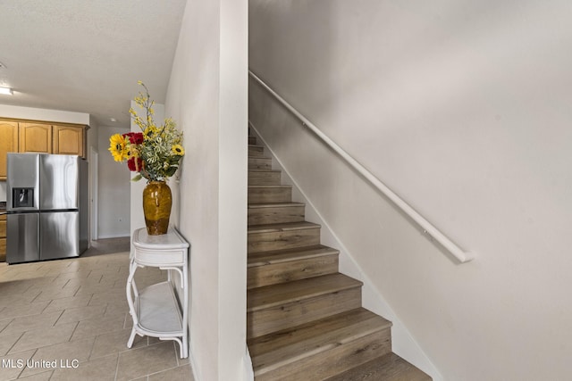 stairs featuring tile patterned flooring