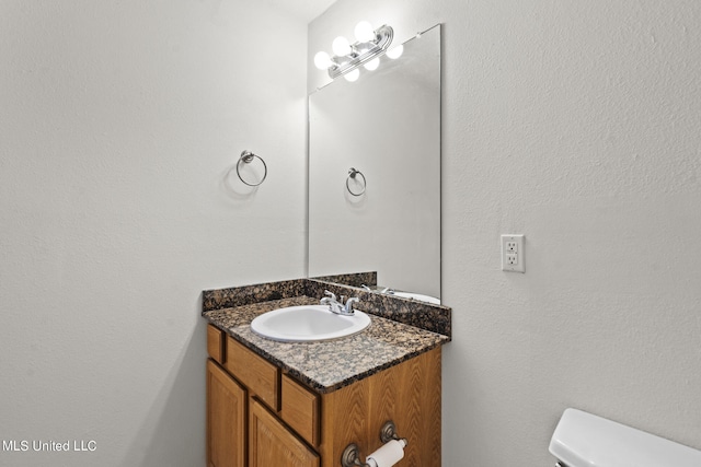 bathroom featuring toilet and vanity