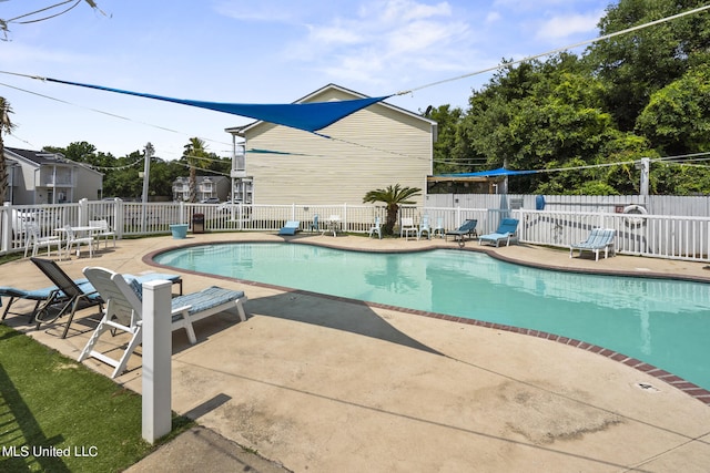 view of swimming pool featuring a patio area