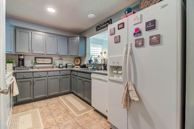 7505 Martin Ct, Ocean Springs, MS 39564 - kitchen featuring white appliances, gray cabinets, light countertops, a sink, and light tile patterned flooring