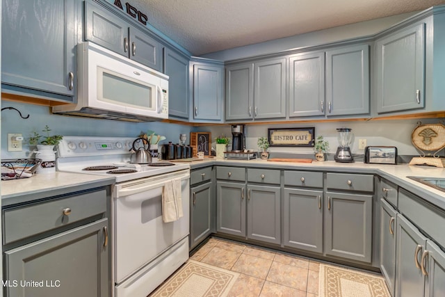 7505 Martin Ct, Ocean Springs, MS 39564 - kitchen with white appliances, gray cabinetry, light countertops, and a textured ceiling