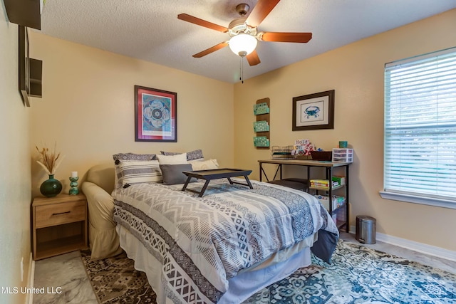 7505 Martin Ct, Ocean Springs, MS 39564 - bedroom featuring multiple windows, baseboards, a textured ceiling, and ceiling fan