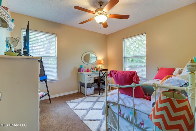 7505 Martin Ct, Ocean Springs, MS 39564 - carpeted bedroom with baseboards, a textured ceiling, and a ceiling fan