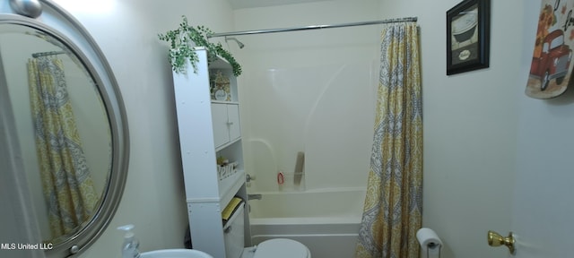 bathroom with shower / bath combo and toilet