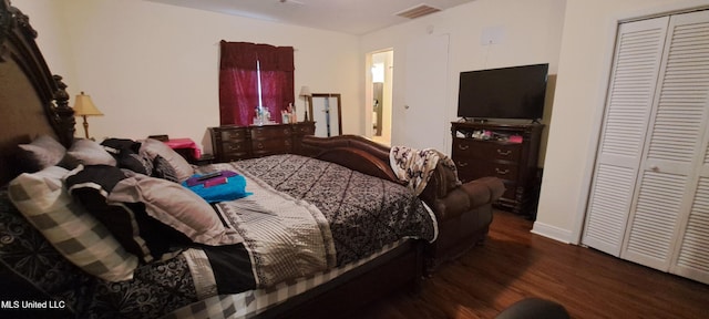 bedroom with a closet and dark wood-type flooring