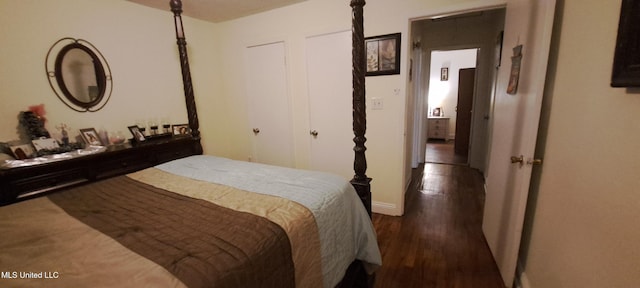 bedroom with dark hardwood / wood-style flooring