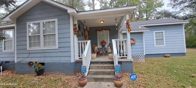 property entrance featuring covered porch