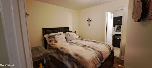 bedroom with dark wood-type flooring and a textured ceiling