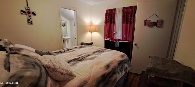 bedroom featuring hardwood / wood-style flooring and ensuite bath