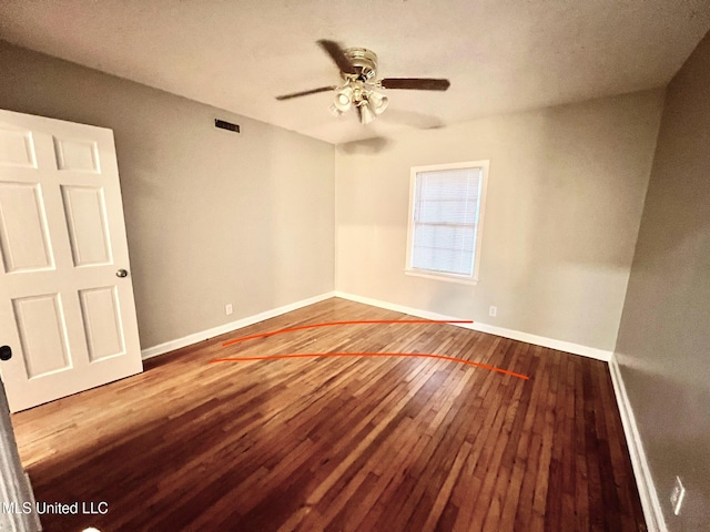 spare room with ceiling fan, wood-type flooring, and a textured ceiling