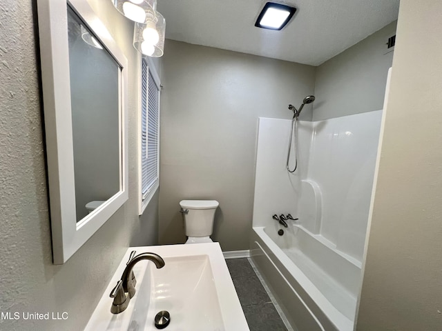 full bathroom featuring tile patterned floors, tub / shower combination, a textured ceiling, sink, and toilet