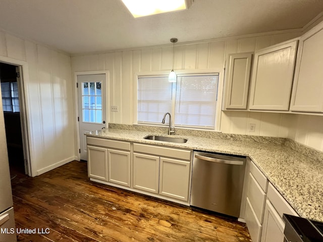 kitchen with stainless steel dishwasher, sink, decorative light fixtures, white cabinets, and dark hardwood / wood-style floors