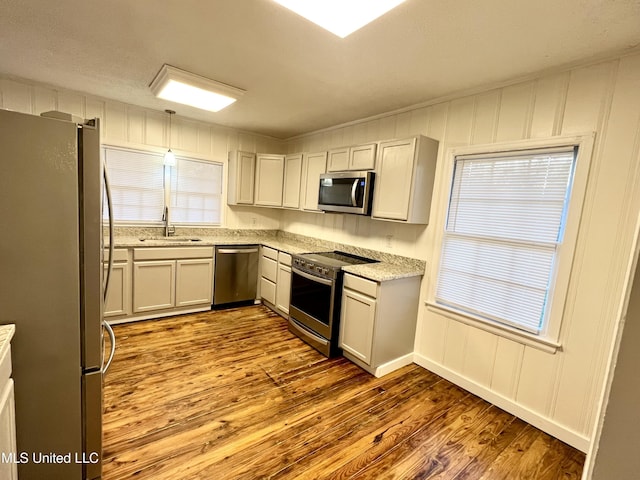 kitchen featuring white cabinetry, light wood-type flooring, sink, and appliances with stainless steel finishes