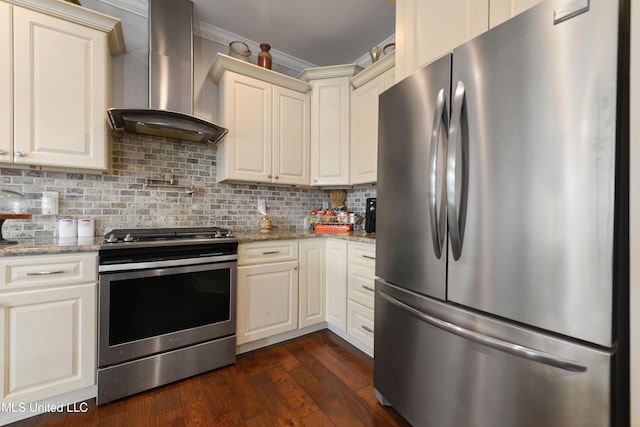 kitchen with dark wood finished floors, decorative backsplash, appliances with stainless steel finishes, crown molding, and wall chimney range hood