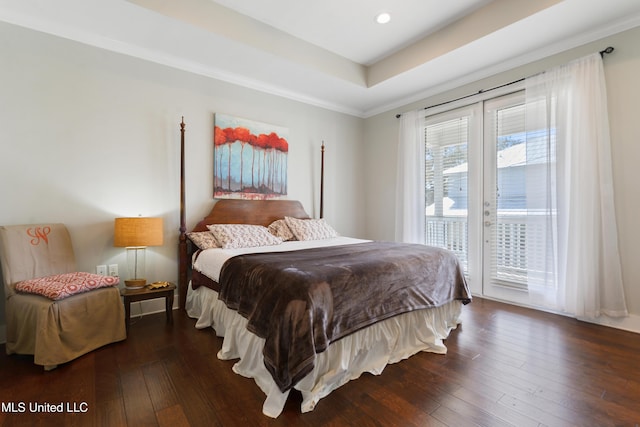 bedroom featuring a tray ceiling, recessed lighting, ornamental molding, hardwood / wood-style flooring, and access to outside