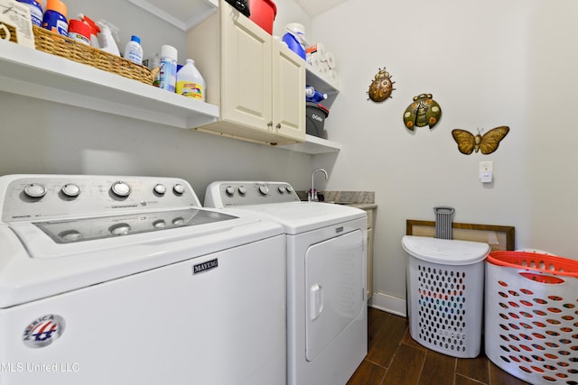 laundry room featuring cabinet space, washer and dryer, and wood tiled floor