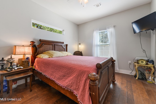 bedroom featuring visible vents, dark wood-style flooring, and baseboards