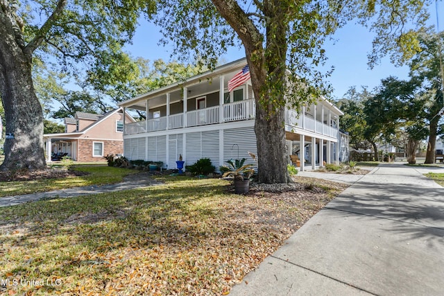 exterior space featuring brick siding and a front yard