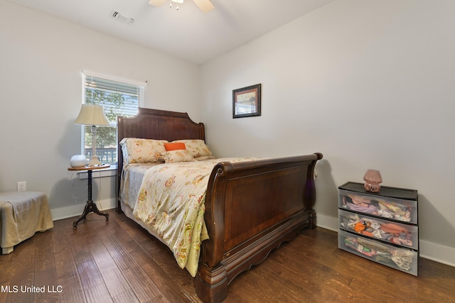 bedroom featuring visible vents, ceiling fan, baseboards, and hardwood / wood-style flooring