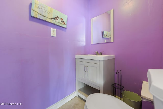 bathroom featuring tile patterned floors, baseboards, and vanity