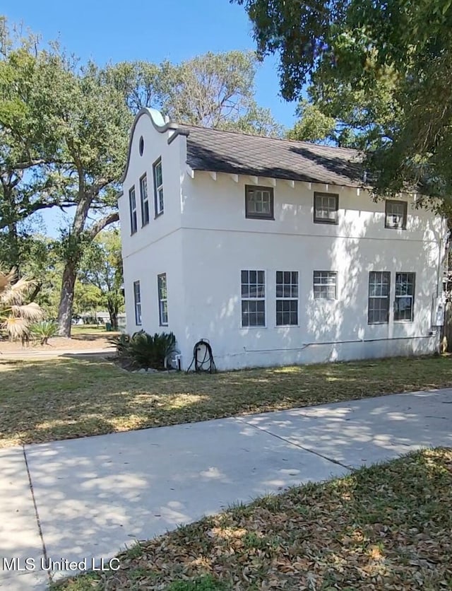 view of home's exterior featuring a yard and stucco siding