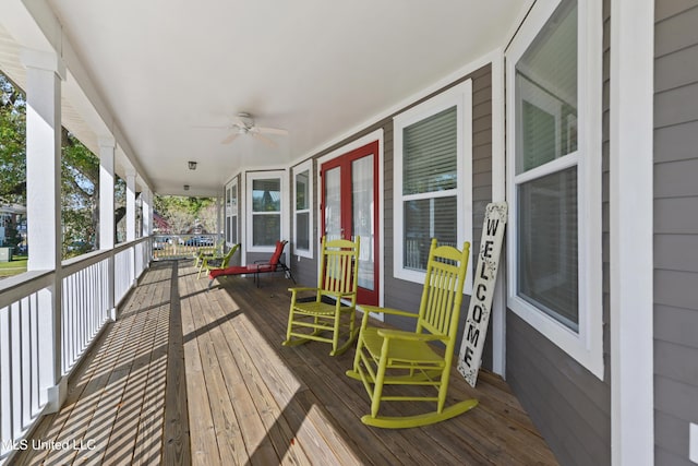 wooden terrace featuring a porch and a ceiling fan