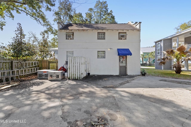 back of house featuring a patio, fence, and stucco siding