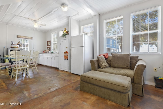 interior space with concrete flooring and a ceiling fan