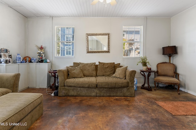 living area with concrete floors and ceiling fan