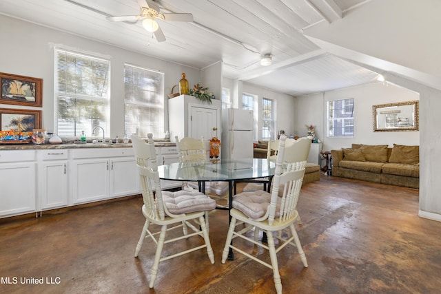 dining space featuring concrete flooring and ceiling fan