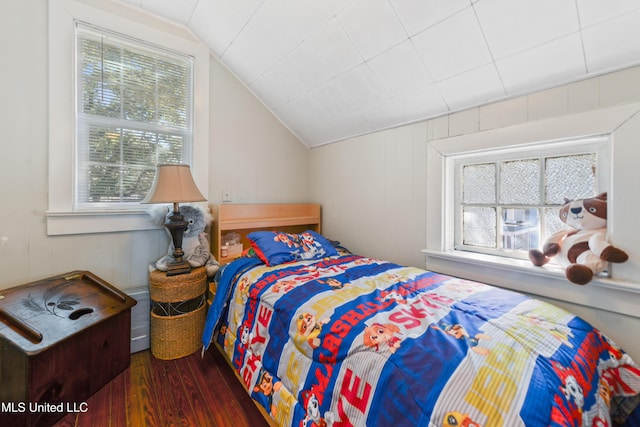 bedroom featuring lofted ceiling and wood finished floors