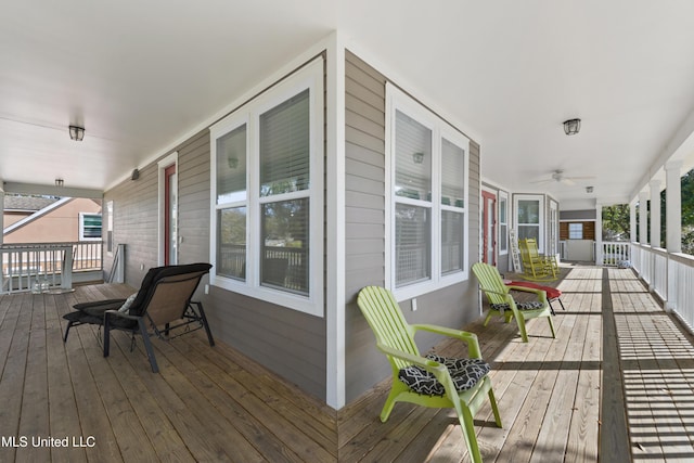 wooden deck featuring a porch and a ceiling fan