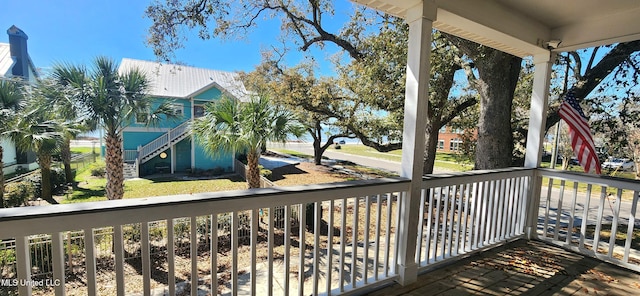 balcony with stairway and a porch