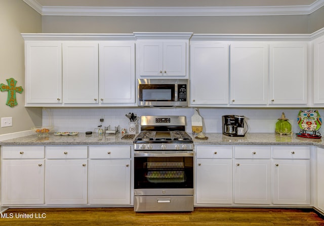 598 Westfield Dr, Pearl, MS 39208 - kitchen featuring stainless steel appliances, white cabinetry, ornamental molding, decorative backsplash, and light stone counters