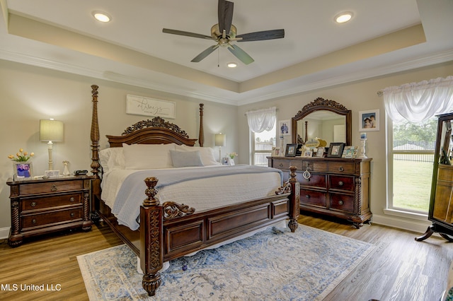 598 Westfield Dr, Pearl, MS 39208 - bedroom featuring a tray ceiling, light wood finished floors, a ceiling fan, recessed lighting, and ornamental molding