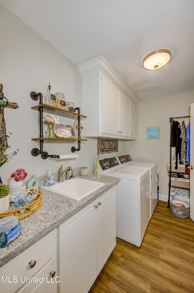 598 Westfield Dr, Pearl, MS 39208 - washroom with separate washer and dryer, light wood finished floors, and cabinet space