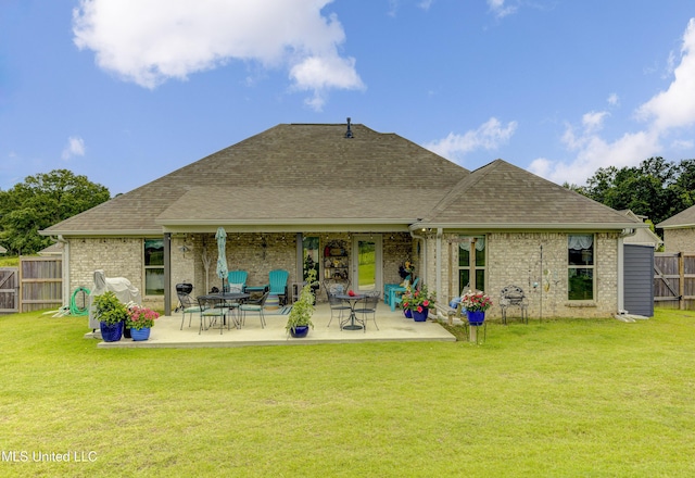 598 Westfield Dr, Pearl, MS 39208 - back of property with roof with shingles, a fenced backyard, a patio area, and brick siding