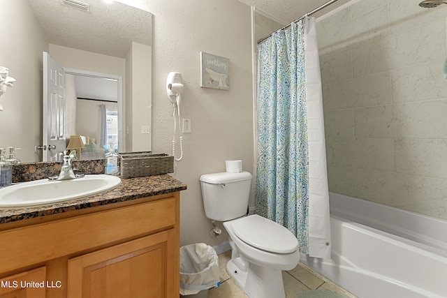 full bathroom featuring shower / bath combination with curtain, a textured ceiling, toilet, vanity, and tile patterned floors