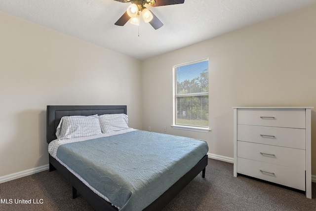 carpeted bedroom featuring a textured ceiling and ceiling fan