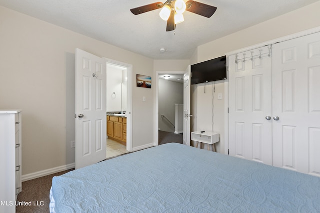 carpeted bedroom with connected bathroom, a closet, and ceiling fan