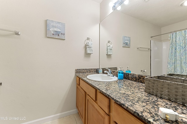 bathroom featuring vanity, a textured ceiling, tile patterned floors, and a shower with shower curtain