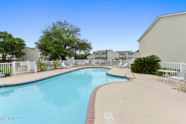 view of swimming pool with a patio