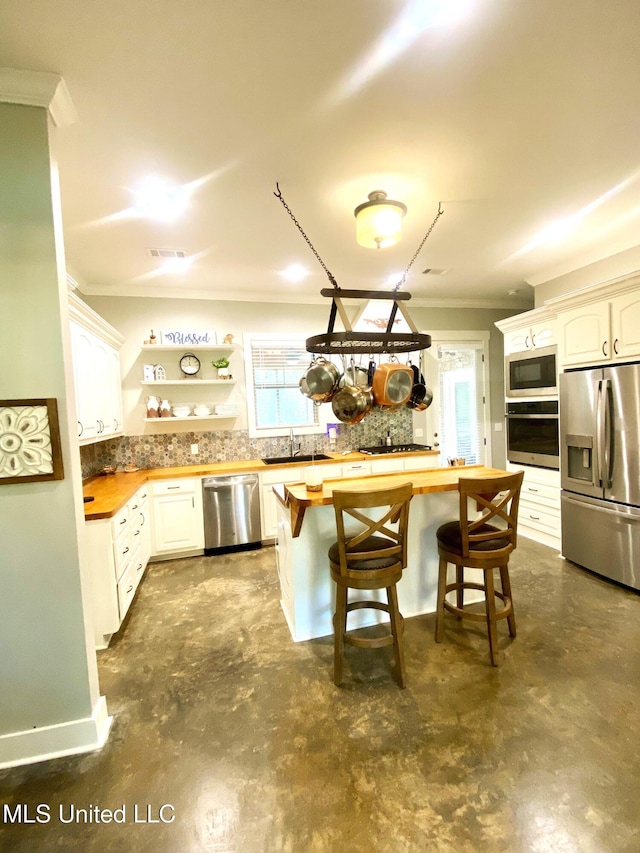 115 Pinedale Rd, Terry, MS 39170 - kitchen featuring appliances with stainless steel finishes, butcher block counters, ornamental molding, and plenty of natural light