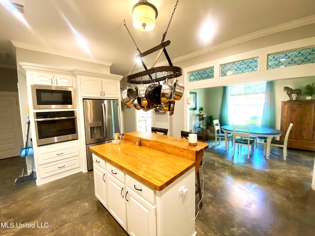115 Pinedale Rd, Terry, MS 39170 - kitchen featuring butcher block counters, stainless steel appliances, concrete flooring, ornamental molding, and white cabinets