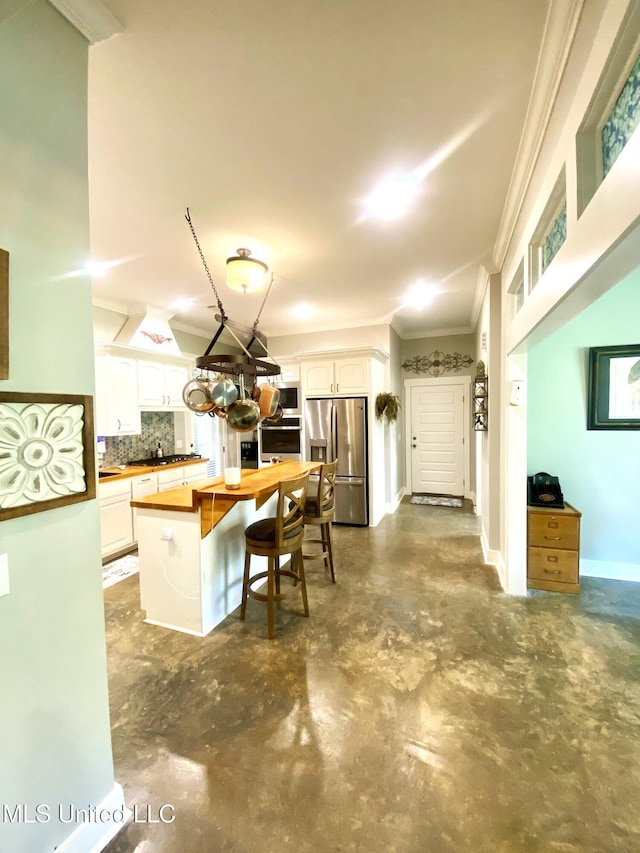 115 Pinedale Rd, Terry, MS 39170 - kitchen featuring stainless steel appliances, crown molding, wooden counters, concrete floors, and backsplash
