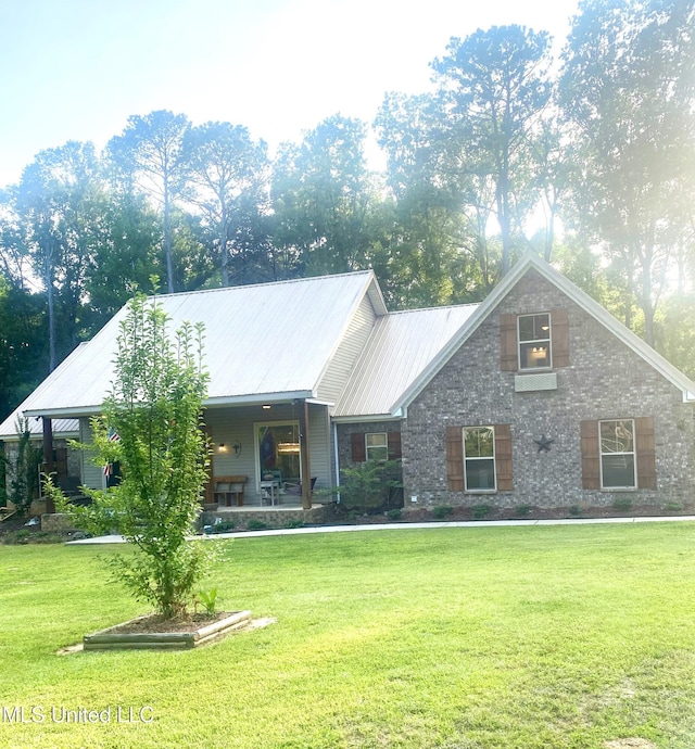 115 Pinedale Rd, Terry, MS 39170 - view of front facade with a front yard, metal roof, and covered porch