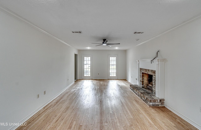 unfurnished living room with a fireplace, light hardwood / wood-style flooring, ceiling fan, and ornamental molding