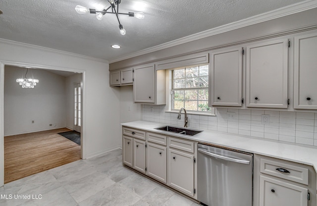 kitchen with dishwasher, sink, light wood-type flooring, a textured ceiling, and ornamental molding