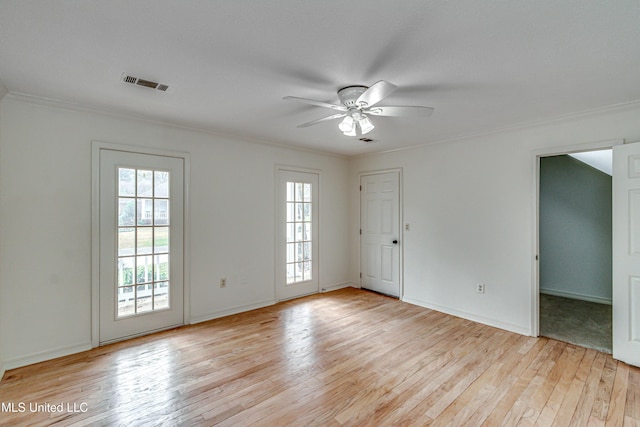 spare room featuring light hardwood / wood-style flooring, a wealth of natural light, and ceiling fan