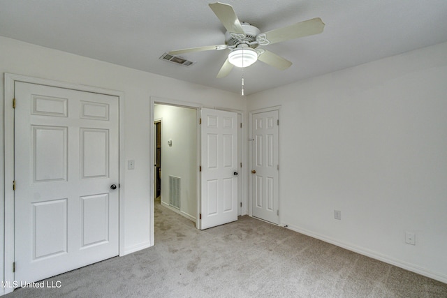 unfurnished bedroom featuring ceiling fan and light carpet